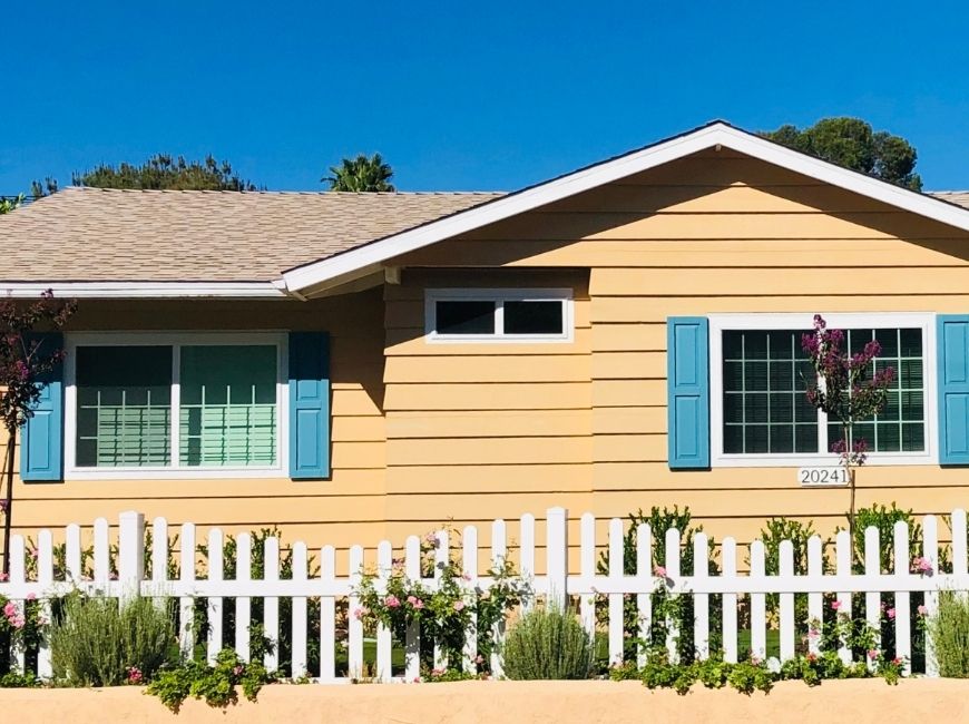 yellow home with light blue shutters