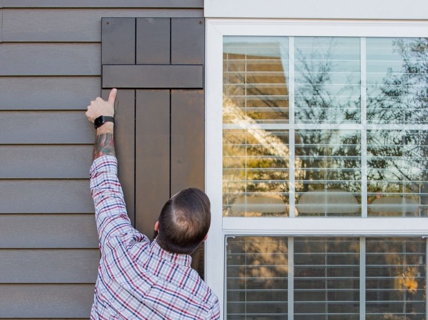 black shutters on a grey house 