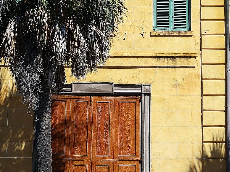 yellow house with blue shutters