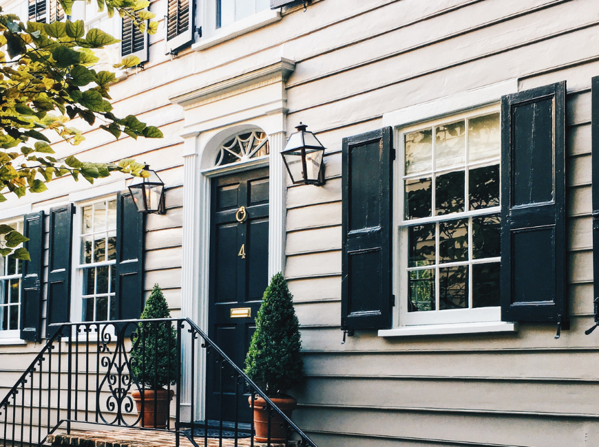 white house with white flat panel shutters