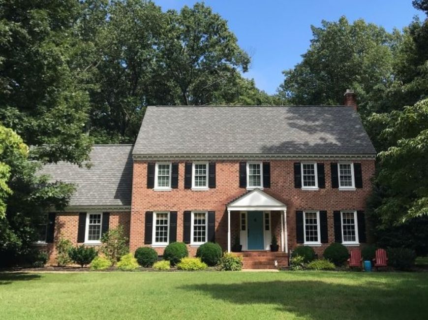 red brick house with black shutters