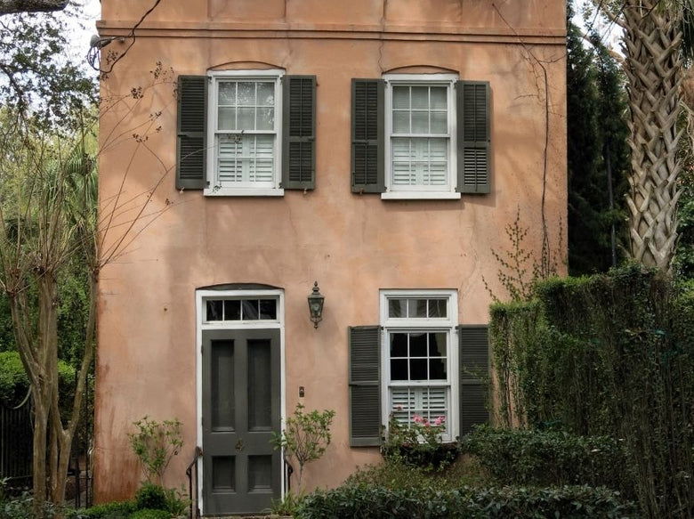 tan house with dark green shutters