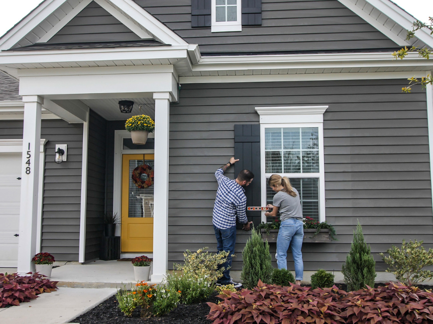 people measuring shutter on window